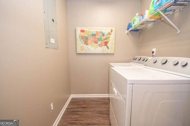 laundry room featuring wood finished floors, separate washer and dryer, electric panel, baseboards, and laundry area