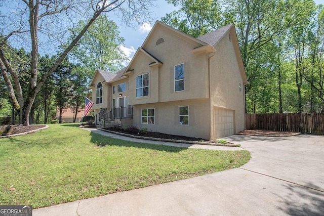 view of property exterior with driveway, fence, a garage, a yard, and stucco siding
