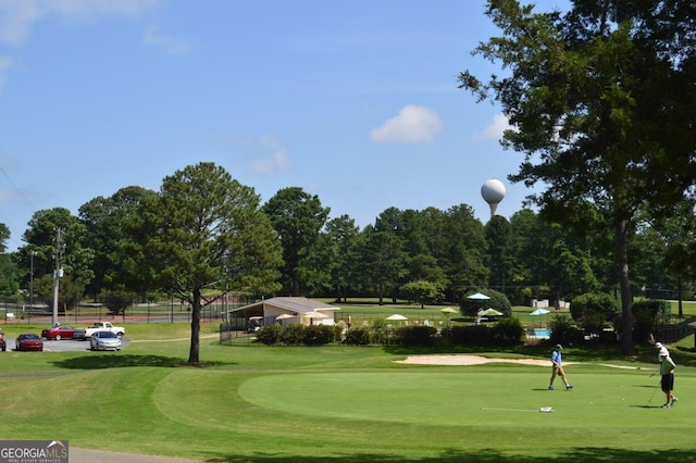 view of property's community featuring a lawn and golf course view