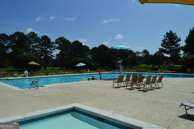 pool featuring a patio and fence