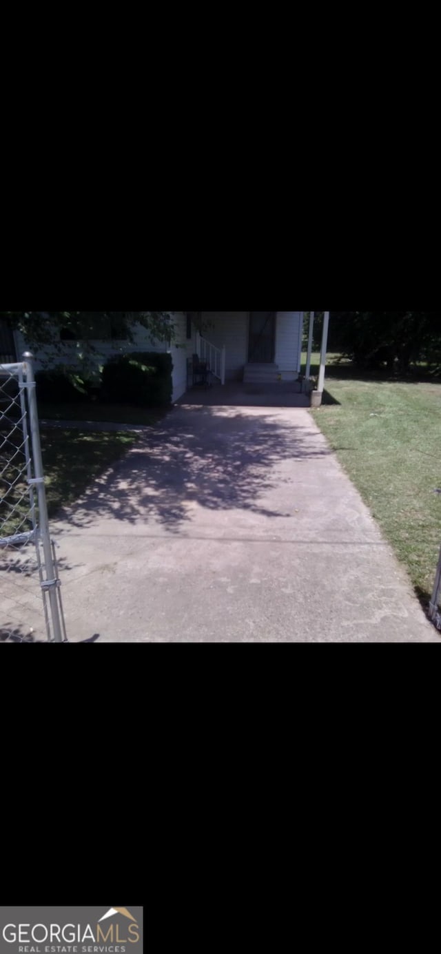 408 Railroad Ave, East Dublin, GA 31027 - view of patio / terrace with driveway and a carport