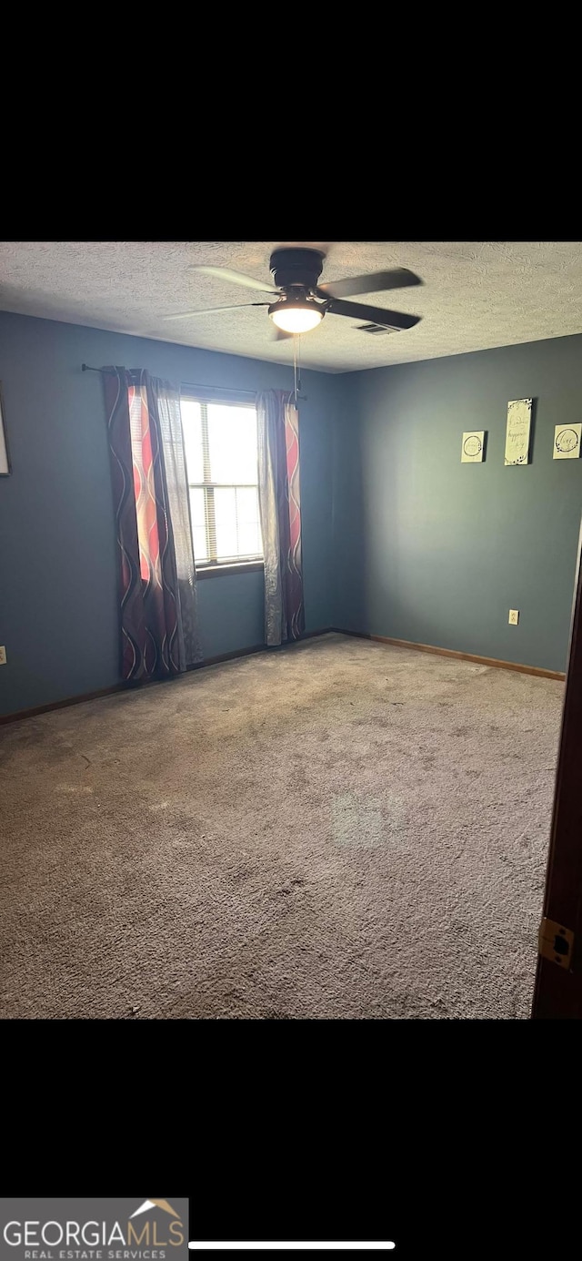 408 Railroad Ave, East Dublin, GA 31027 - carpeted spare room with a textured ceiling and ceiling fan