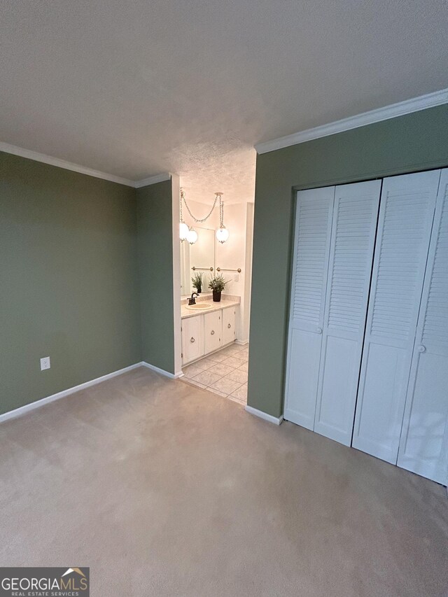 3411 Ponderosa Rd, Portal, GA 30450 - unfurnished bedroom featuring crown molding, light carpet, ensuite bath, a closet, and a chandelier
