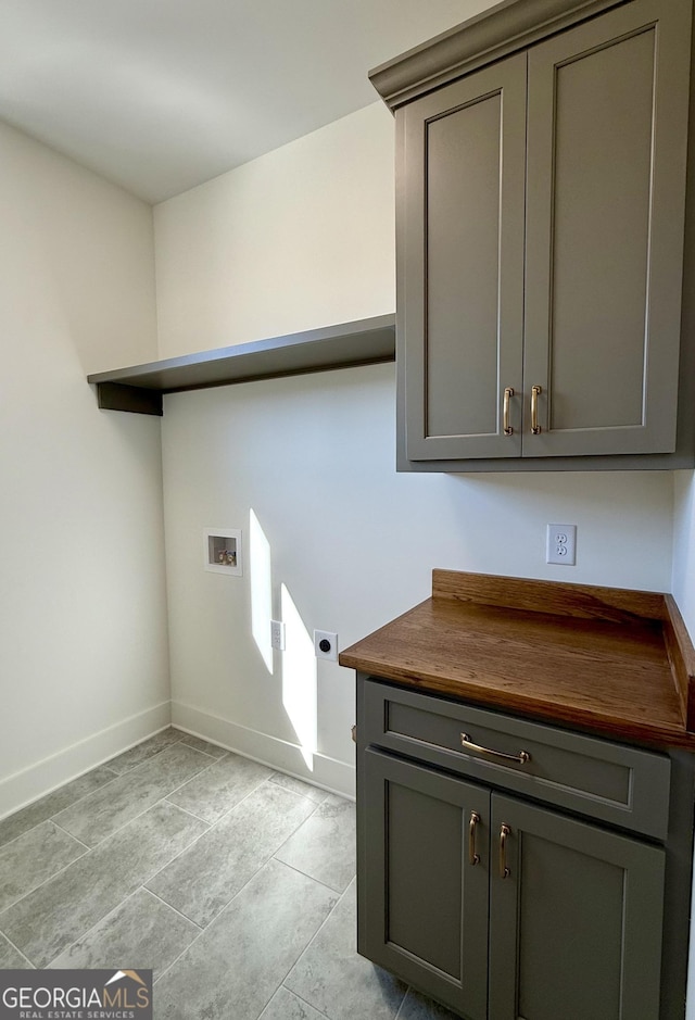 laundry room with cabinet space, baseboards, electric dryer hookup, and hookup for a washing machine