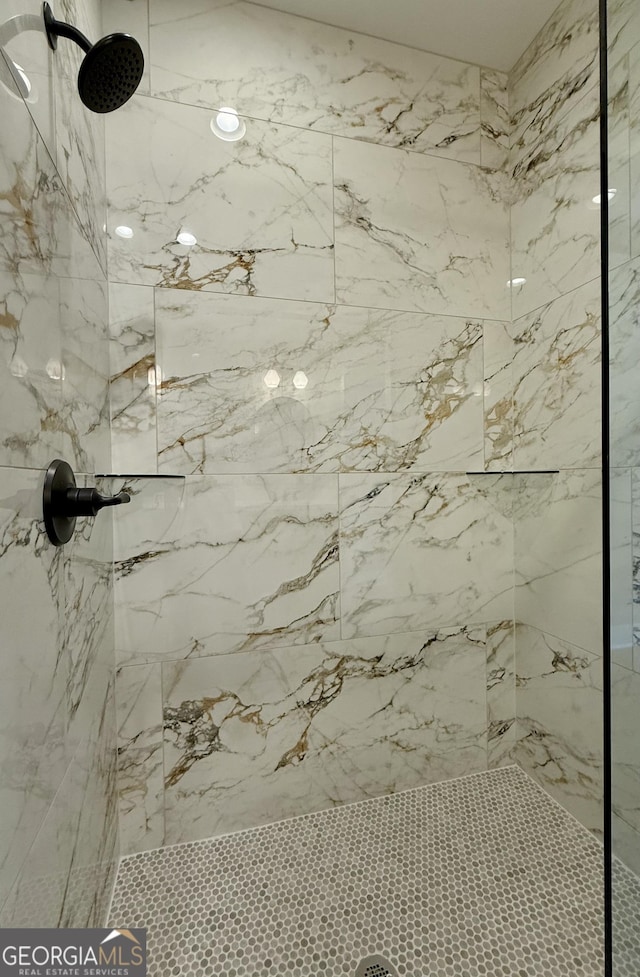 full bathroom with a marble finish shower