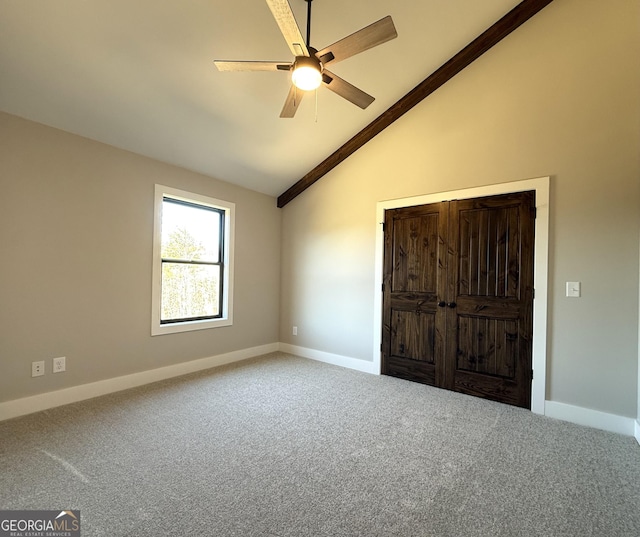 unfurnished bedroom with baseboards, carpet, and lofted ceiling