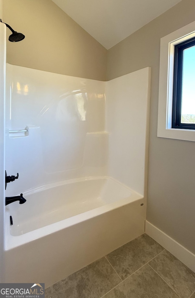 full bath featuring tile patterned flooring, baseboards, and shower / bathing tub combination