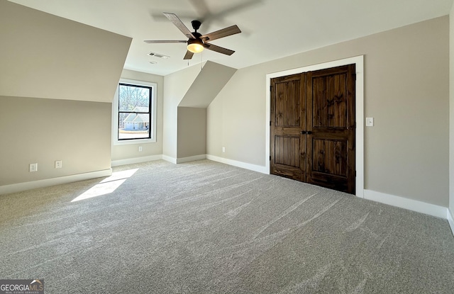 additional living space featuring visible vents, baseboards, a ceiling fan, and carpet