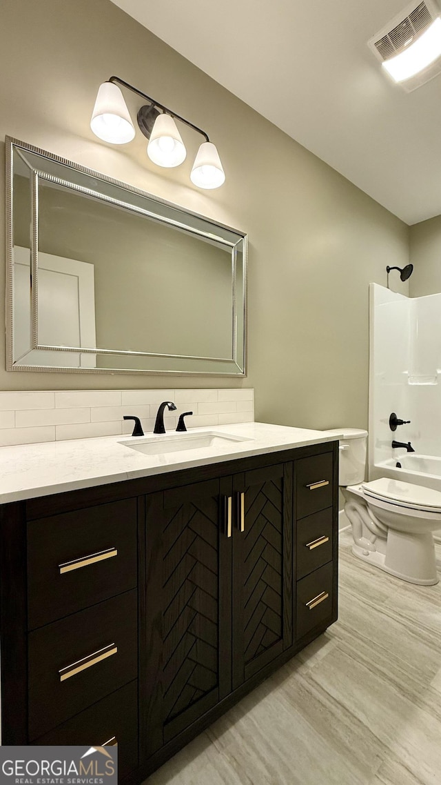 full bath featuring vanity, visible vents, toilet, and decorative backsplash