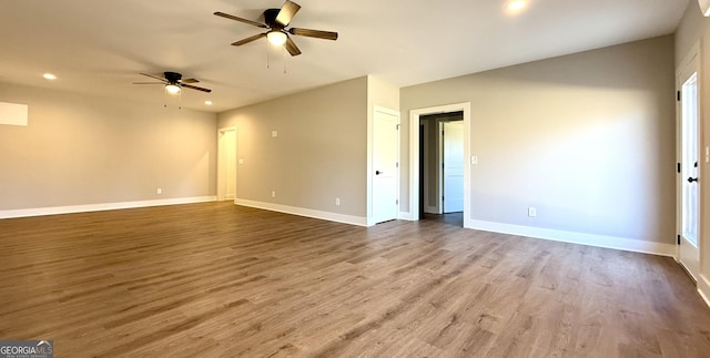 interior space with recessed lighting, baseboards, a ceiling fan, and wood finished floors