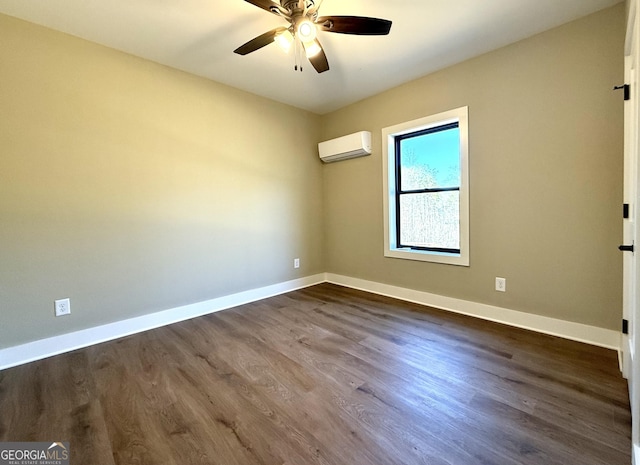 empty room featuring dark wood-style flooring, an AC wall unit, baseboards, and ceiling fan