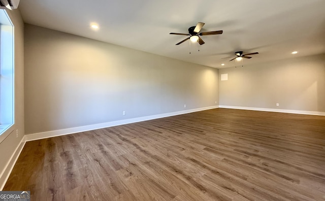 spare room featuring recessed lighting, ceiling fan, baseboards, and wood finished floors