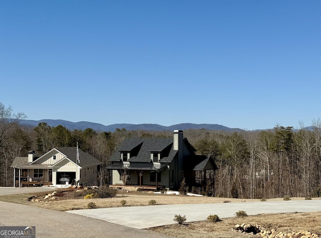 property view of mountains featuring a forest view