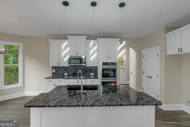 6048 Golf View Xing, Locust Grove, GA 30248 - kitchen with appliances with stainless steel finishes, dark wood-type flooring, backsplash, white cabinets, and an island with sink