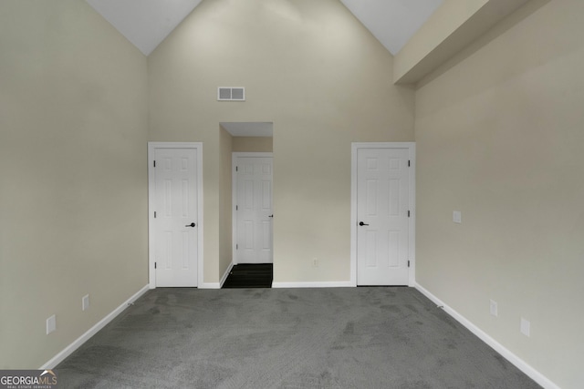 6048 Golf View Xing, Locust Grove, GA 30248 - empty room featuring high vaulted ceiling and dark carpet