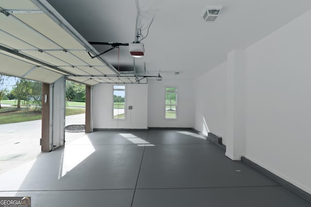 6048 Golf View Xing, Locust Grove, GA 30248 - garage with baseboards and a garage door opener
