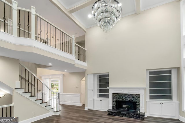6048 Golf View Xing, Locust Grove, GA 30248 - unfurnished living room featuring a high ceiling, wood finished floors, a chandelier, stairs, and a premium fireplace