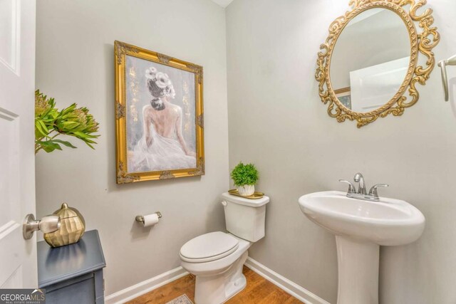 1302 Gardenia Ct, Villa Rica, GA 30180 - bathroom with baseboards, a sink, toilet, and wood finished floors