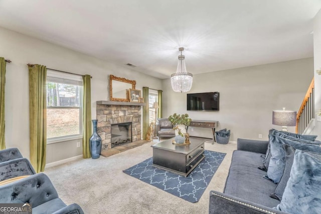 1302 Gardenia Ct, Villa Rica, GA 30180 - carpeted living room featuring visible vents, baseboards, an inviting chandelier, and a fireplace