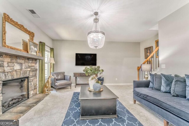 1302 Gardenia Ct, Villa Rica, GA 30180 - carpeted living room with visible vents, baseboards, a stone fireplace, a chandelier, and stairs