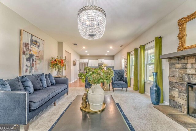 1302 Gardenia Ct, Villa Rica, GA 30180 - living room featuring visible vents, a stone fireplace, an inviting chandelier, and baseboards
