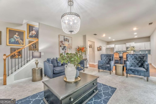 1302 Gardenia Ct, Villa Rica, GA 30180 - living room featuring visible vents, an inviting chandelier, carpet floors, and stairs