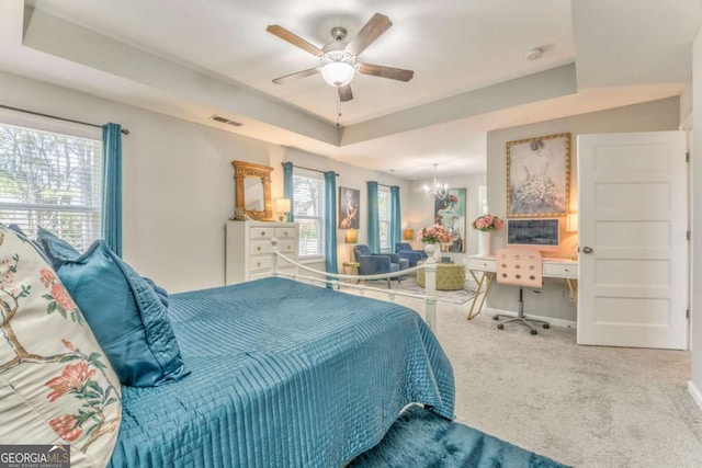 1302 Gardenia Ct, Villa Rica, GA 30180 - bedroom with visible vents, baseboards, a raised ceiling, carpet floors, and ceiling fan with notable chandelier