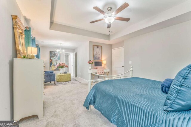 1302 Gardenia Ct, Villa Rica, GA 30180 - bedroom with a tray ceiling, baseboards, a ceiling fan, and carpet flooring
