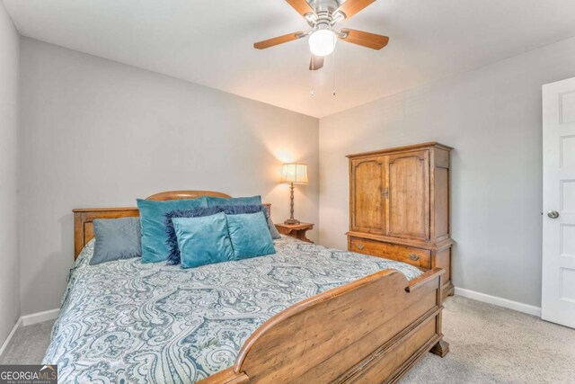 1302 Gardenia Ct, Villa Rica, GA 30180 - bedroom featuring baseboards, a ceiling fan, and light carpet