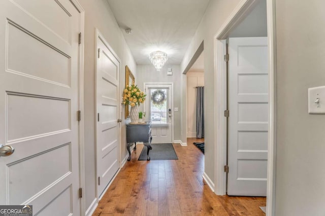 1302 Gardenia Ct, Villa Rica, GA 30180 - interior space featuring light wood finished floors, baseboards, and a notable chandelier