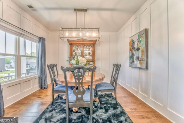 1302 Gardenia Ct, Villa Rica, GA 30180 - dining room featuring a decorative wall, visible vents, and light wood-type flooring