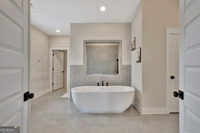196 Saddleridge Trl, Senoia, GA 30276 - full bath featuring a freestanding bath, baseboards, tile patterned flooring, and recessed lighting