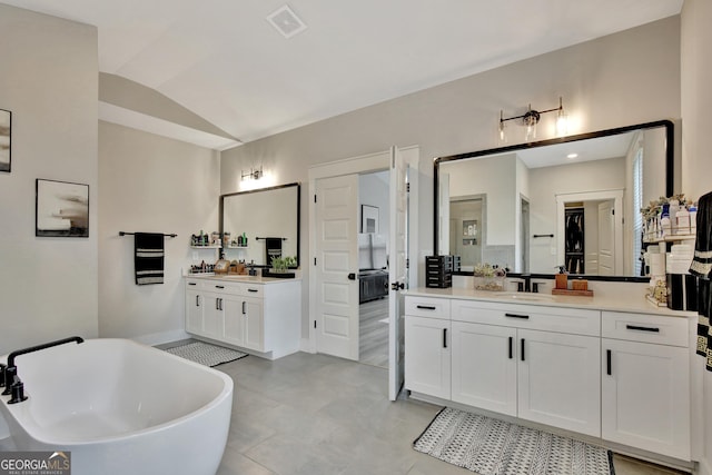 196 Saddleridge Trl, Senoia, GA 30276 - full bath featuring visible vents, a sink, a soaking tub, two vanities, and lofted ceiling