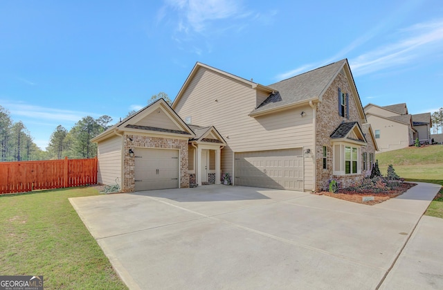196 Saddleridge Trl, Senoia, GA 30276 - view of front of house with an attached garage, driveway, fence, and a front lawn