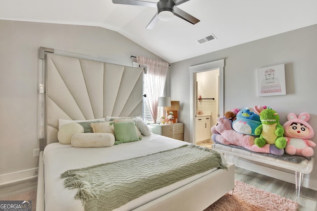 196 Saddleridge Trl, Senoia, GA 30276 - bedroom with baseboards, light wood-type flooring, vaulted ceiling, ensuite bath, and visible vents