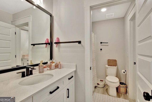 196 Saddleridge Trl, Senoia, GA 30276 - full bathroom featuring vanity, baseboards, toilet, visible vents, and wood finished floors