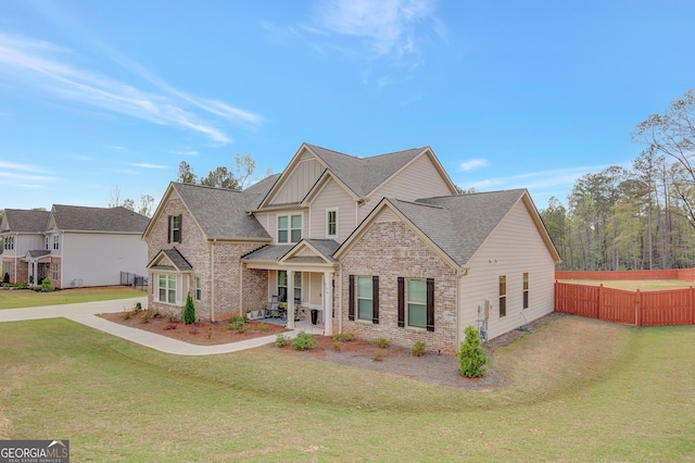 196 Saddleridge Trl, Senoia, GA 30276 - craftsman inspired home featuring a front yard, brick siding, fence, and a shingled roof