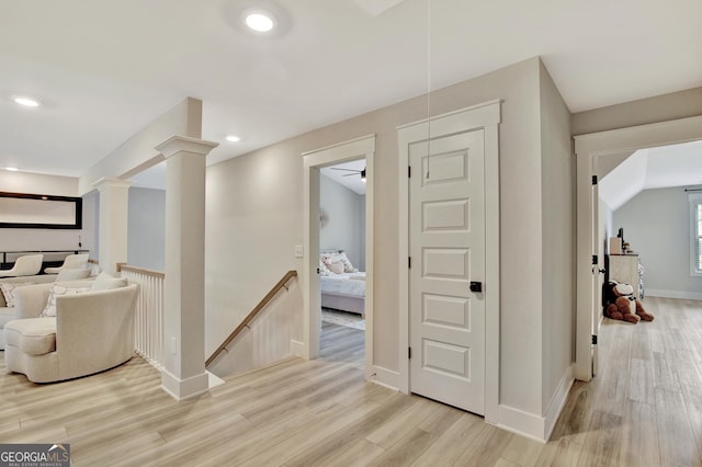 196 Saddleridge Trl, Senoia, GA 30276 - hall with baseboards, recessed lighting, an upstairs landing, light wood-style flooring, and ornate columns