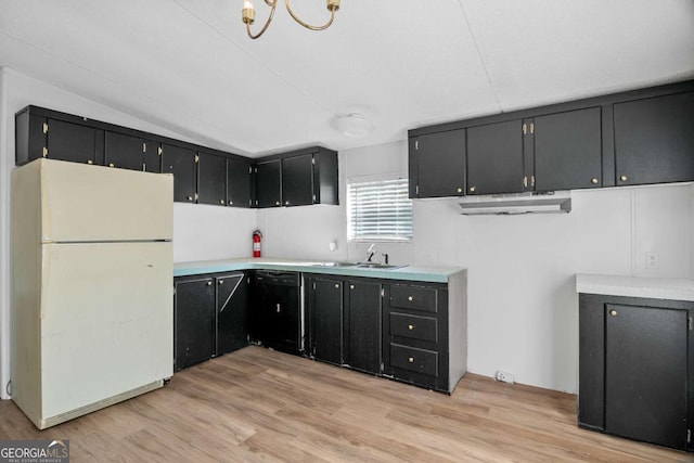 6603 Christie Cir, Blackshear, GA 31516 - kitchen featuring freestanding refrigerator, black dishwasher, dark cabinetry, a sink, and light wood-type flooring