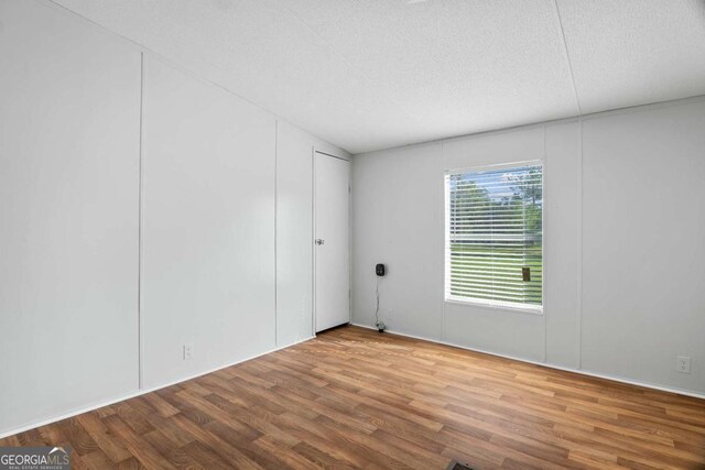 6603 Christie Cir, Blackshear, GA 31516 - empty room featuring wood finished floors and a textured ceiling