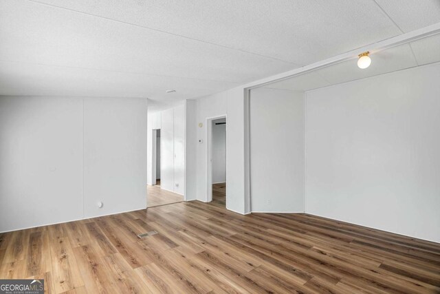 6603 Christie Cir, Blackshear, GA 31516 - empty room with wood finished floors and a textured ceiling