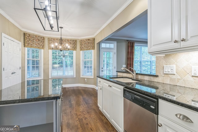 kitchen featuring stainless steel dishwasher, an inviting chandelier, dark stone counters, a sink, and white cabinetry
