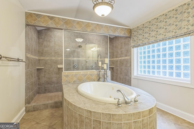 bathroom with a whirlpool tub, a tile shower, tile patterned floors, and baseboards