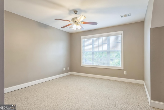 empty room featuring baseboards, visible vents, ceiling fan, and carpet flooring