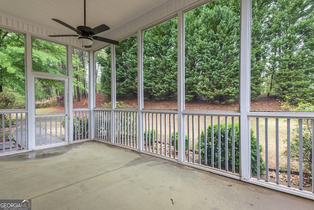 unfurnished sunroom with ceiling fan