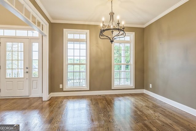 entryway with wood finished floors, a chandelier, a healthy amount of sunlight, and baseboards