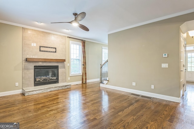 unfurnished living room with visible vents, wood finished floors, ceiling fan, and crown molding