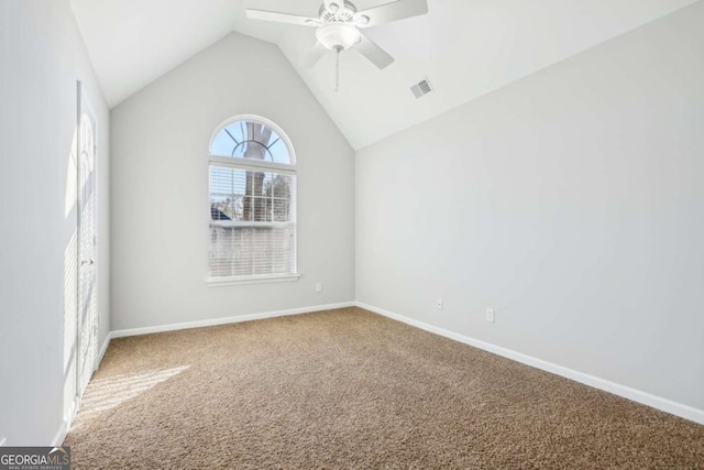 spare room featuring visible vents, baseboards, a ceiling fan, carpet, and lofted ceiling