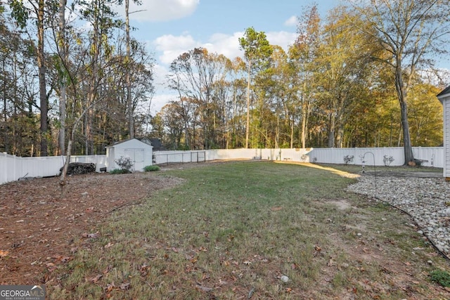 view of yard featuring a fenced backyard, a shed, and an outdoor structure