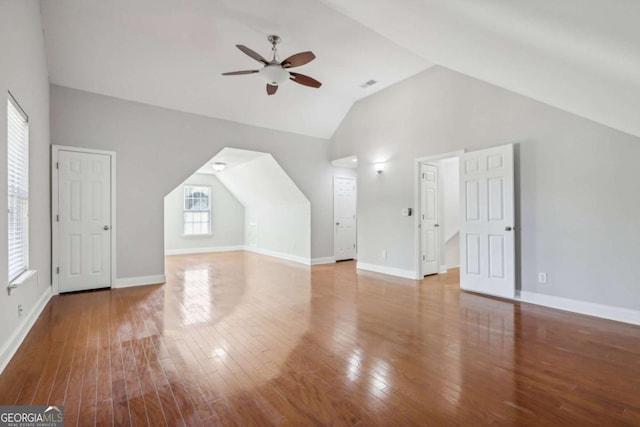 bonus room featuring hardwood / wood-style floors, ceiling fan, baseboards, and visible vents